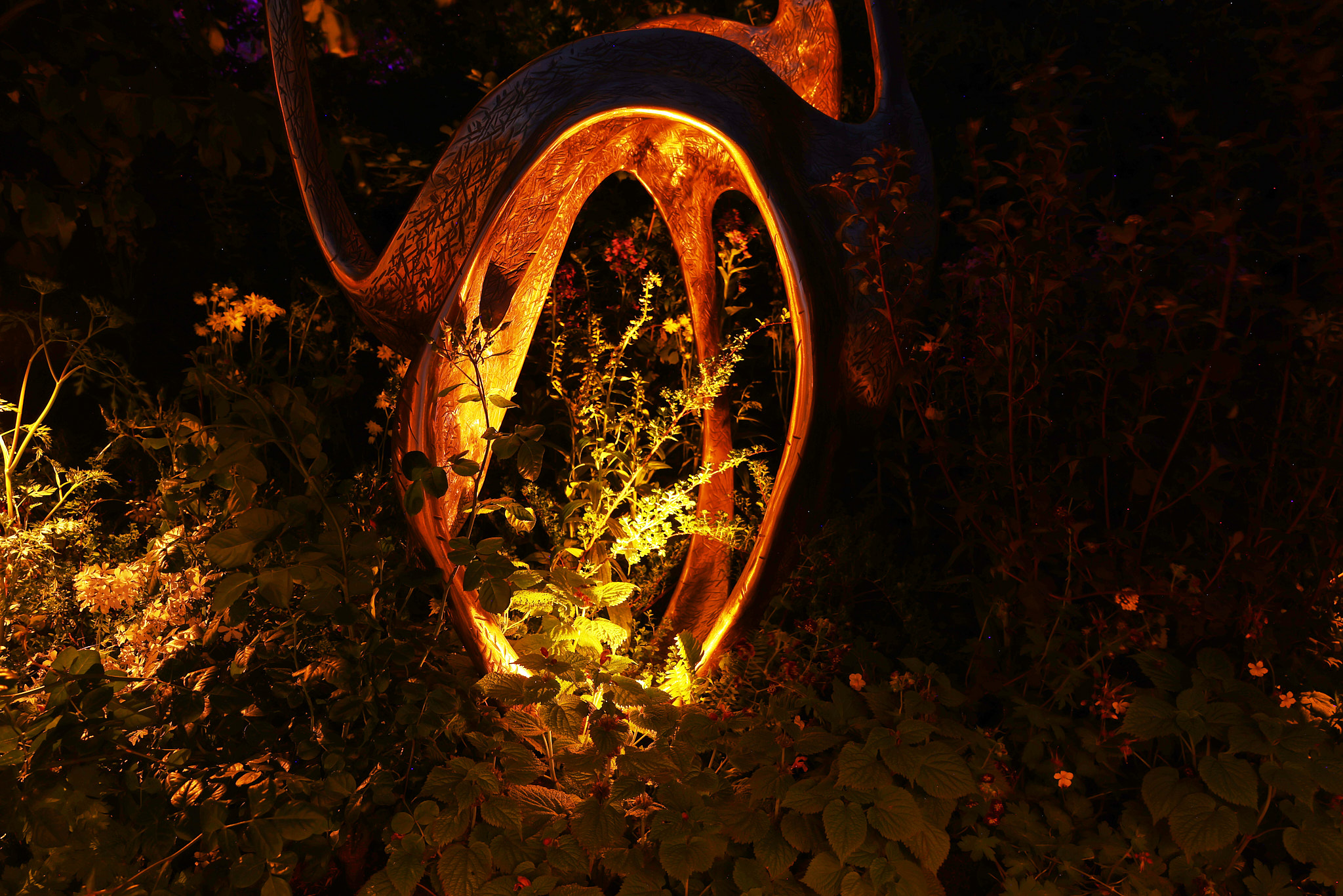 Jack Eagan's sculpture in the Parkinson's UK garden, lit by Hudson Lighting micro spike spots carefully positioned within the form